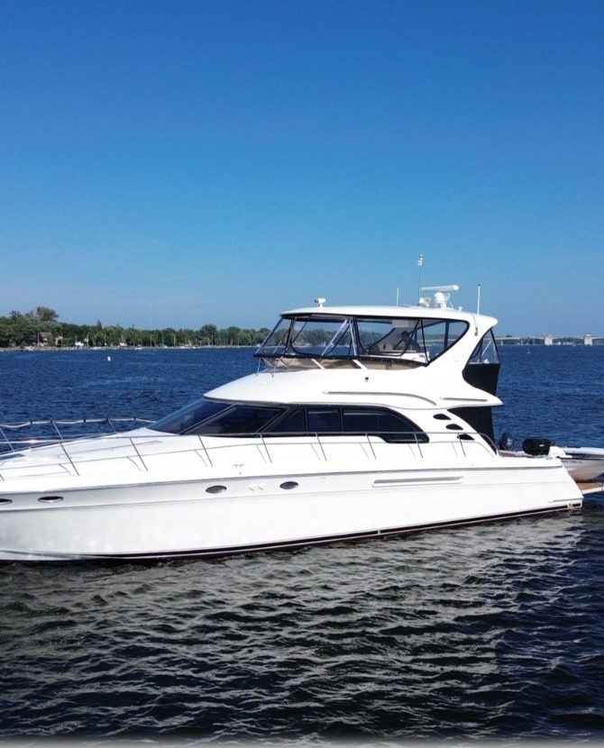 Sea Ya Later, a private motor yacht, cruising calm water under a clear sky